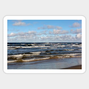 White cumulus clouds in sky over wavy Baltic sea Sticker